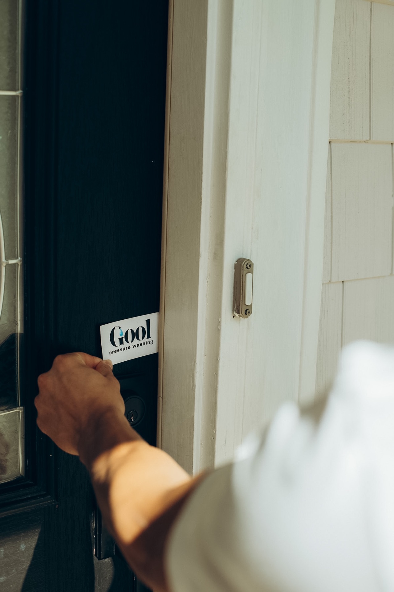 GOOL Pressure Washing card placed on a Charlotte front door