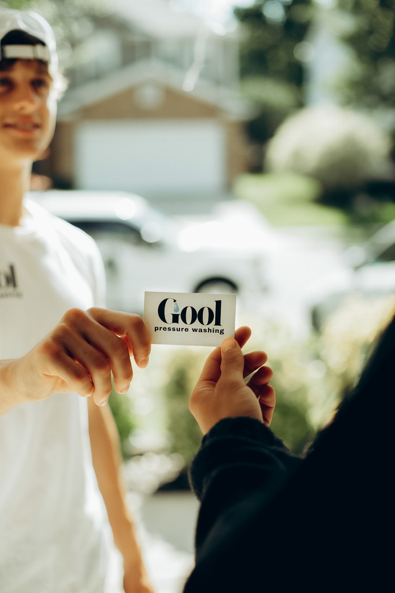 GOOL team member handing a business card to a Charlotte homeowner