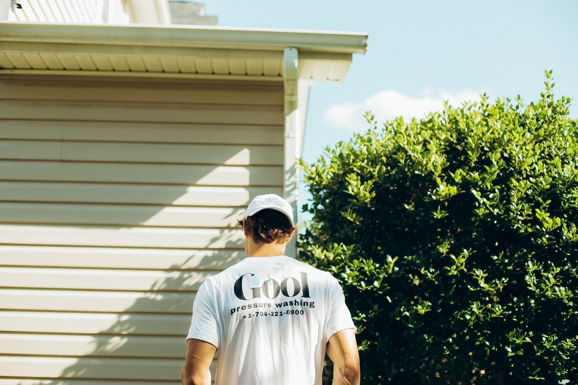 GOOL crew member inspecting a freshly washed Charlotte home