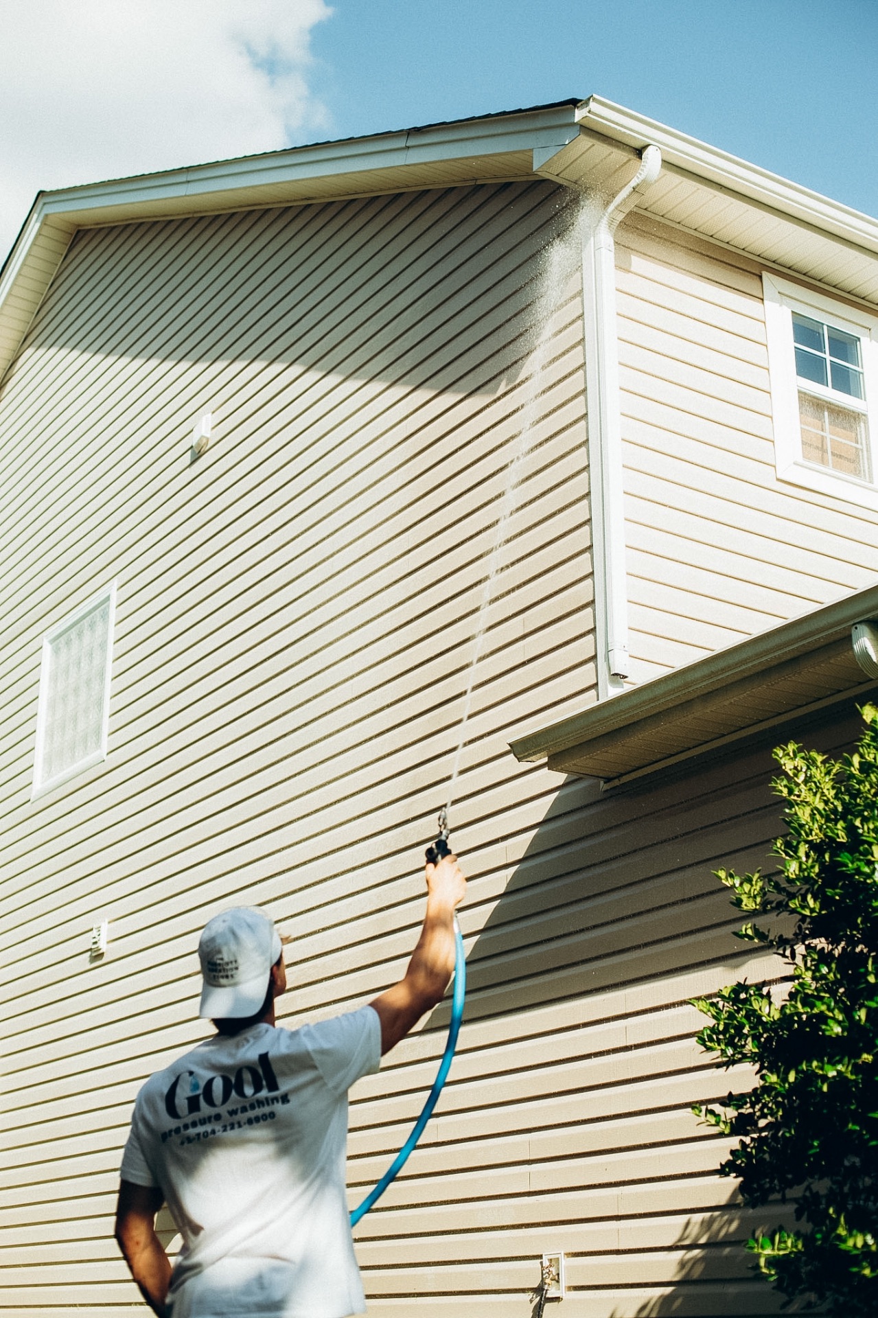 GOOL technician washing house siding in Charlotte